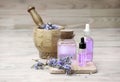 Lavender flowers bouquet and essential oil in glass bottle on wooden table. Relax therapy concept. Beauty and aromatherapy