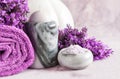 Lavender flowers, candle in the marble candlestick, aroma bath salt and towels. Concept for spa, beauty and health salon, Royalty Free Stock Photo