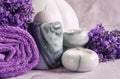 Lavender flowers, candle in the marble candlestick and towels. Concept for spa, beauty and health salon, cosmetics store. Close up Royalty Free Stock Photo