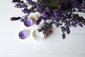 Lavender flowers, candles and cream on a white wooden background. Royalty Free Stock Photo