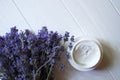 Lavender flowers, candles and cream on a white wooden background. Royalty Free Stock Photo