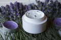 Lavender flowers, candles and cream on a white wooden background. Royalty Free Stock Photo