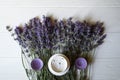 Lavender flowers, candles and cream on a white wooden background. Royalty Free Stock Photo