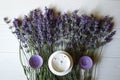 Lavender flowers, candles and cream on a white wooden background. Royalty Free Stock Photo