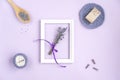 Lavender flowers in a frame on a purple background.