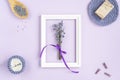 avender flowers in a frame on a purple background. cosmetic set with lavender herbs, handmade soap bars and sea salt. Royalty Free Stock Photo