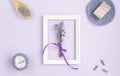 Lavender flowers in a frame on a purple background. cosmetic set with lavender herbs, handmade soap bars and sea salt. Royalty Free Stock Photo