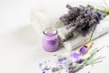 Lavender flowers, products and white towels on the white background. Bath aromatherapy, health care concept Royalty Free Stock Photo