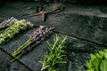 Lavender flowers, rosemary, mint, thyme, melissa with old scissors on a black wooden table. Burnt wood. Spa and cosmetic or cookin Royalty Free Stock Photo