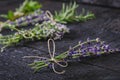 Lavender flowers, rosemary, mint, thyme, melissa with old scissors on a black wooden table. Burnt wood. Spa and cosmetic or cookin Royalty Free Stock Photo