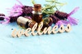 Lavender herbal oil and lavender flowers. bottle of lavender massage oil for aromatherapy treatment and wellness letters made of