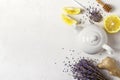 Lavender herbal tea in a white teapot, lemon and ginger