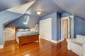 Lavender interior of attic bedroom with queen size bed Royalty Free Stock Photo