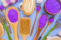 Lavender lilac salt and body brushes.Floral bath salt with lavender extract and body care brushes on a blue background Royalty Free Stock Photo