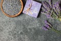 Lavender natural soap with fresh lavender flowers and dried lavender seeds on grey rustic table Royalty Free Stock Photo