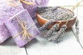 Lavender natural soap with fresh lavender flowers and dried lavender seeds on white rustic table Royalty Free Stock Photo