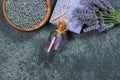 Lavender natural soap and lavender oil with fresh lavender flowers and dried lavender seeds on grey rustic table Royalty Free Stock Photo