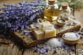 Lavender, oil essence, handmade soap and sea salt on a wooden background. Royalty Free Stock Photo