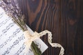 Lavender and paper music notes on old wooden background in vintage style.