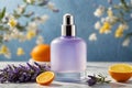 Lavender perfume in glass bottle with orange and lavender flowers on blue background