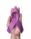Lavender purple awareness ribbon on helping hand support for World Alzheimers day (month) and World cancer day concept Royalty Free Stock Photo
