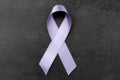 Lavender ribbon on dark background. Cancer and epilepsy