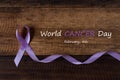 Lavender ribbon symbol of all type of cancer on wooden table Royalty Free Stock Photo