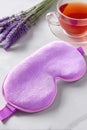 Lavender sleep mask with tea on white background for relaxation and tranquility Royalty Free Stock Photo