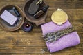 Lavender spa composition, home spa day with lavender products, top view of spa still life towels, lavender oil, natural soap, bath Royalty Free Stock Photo
