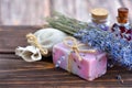 Lavender spa products on wooden table. Body care products with lavender: soap, oil, salt and dried lavender flowers. Selective Royalty Free Stock Photo