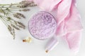 Lavender spa setting: salt, essential oil and dried flowers natural spa products and decor for bath on light background