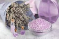 Lavender spa setting: salt, essential oil and dried flowers natural spa products and decor for bath on light background Royalty Free Stock Photo