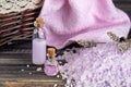 Lavender spa setting: salt, essential oil and dried flowers natural spa products and decor for bath on light background