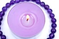 Lavender tea light candle surrounded by royal purple amethyst bead bracelet