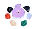 Lavender tea light candle surrounded by set of seven healing chakra stones for crystal healing, Royalty Free Stock Photo
