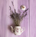 Lavender teapot kettle top view violet background flowers vintage rustic village