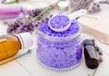 Lavender violet sea salt with essential oil and lavender flowers. Lavender bath products Aromatherapy treatment on white wooden Royalty Free Stock Photo