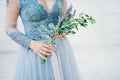 Lavender Wedding bouquet in hands of the bride in white-blue dre