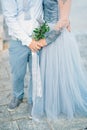 Lavender Wedding bouquet in hands of the bride in white-blue dre