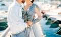 Lavender Wedding bouquet in hands of the bride in white-blue dre