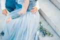 Lavender Wedding bouquet lies on the stairs next to the bride an