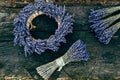 Lavender wreath and bunches of dried lavender on wooden texture. Decoration made of dried lavender. Top view of lavender products Royalty Free Stock Photo