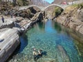 Tourists visiting the famous roman bridge of Lavertezzo on Verzasca valley on the italian part of Switzerland Royalty Free Stock Photo