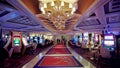 Lavish Casino Floor with Rich Ornamentation and Vibrant Slot Machines