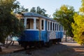 Lavrio, Greece - July 28, 2021: Old tram in a park in Lavrio. Covered in graffiti and without window glass..Discarded tram between