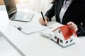 Law, agreement, contract, mortgage, woman holding a pen, reading the contract document in buying a house to see the