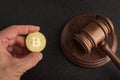 Law or auction gavel and bitcoins in hand. Dispute resolution on bitcoin frauds. Cryptocurrency legislation Royalty Free Stock Photo