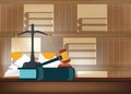 Law books with a judge`s gavel on a table and book shelves on ba