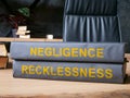 Law books about negligence and recklessness on the desk.