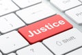 Law concept: Justice on computer keyboard background Royalty Free Stock Photo